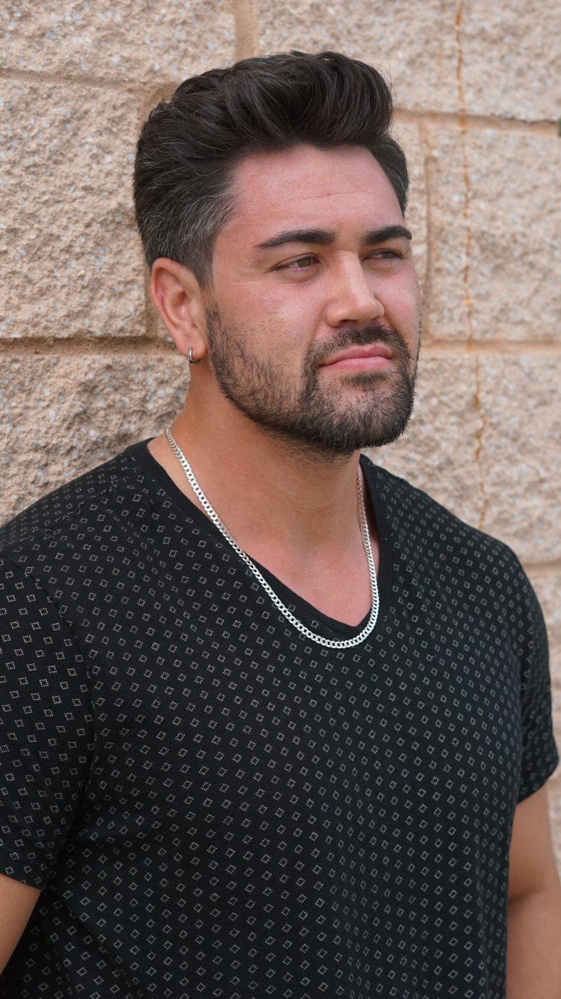 Full beard sculpt with a swept-back cut